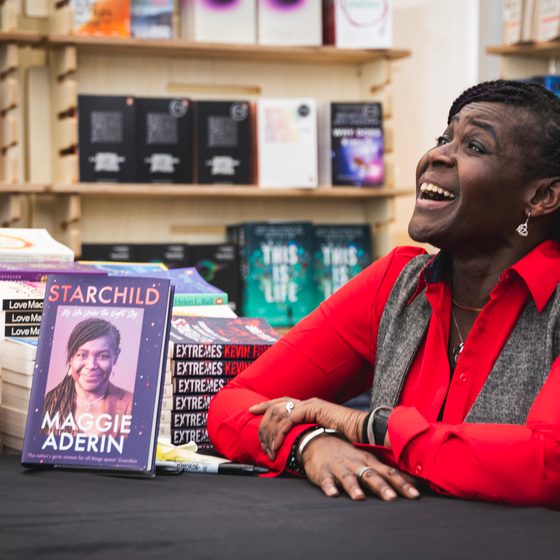 Maggie Aderin smiling at her book signing in Waterstones Bookshop