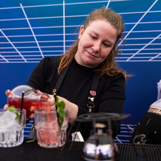 A woman making cocktails in The Arcade