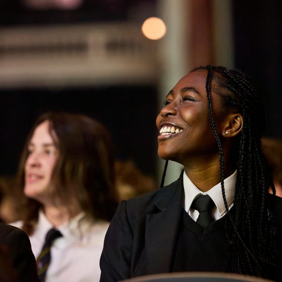 A secondary school pupil smiling up during an event at Cheltenham Science Festival